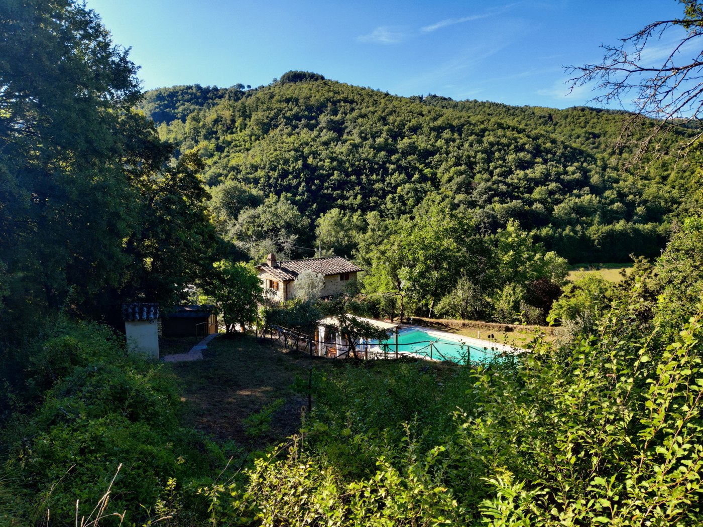 The private pool on the second garden level and the wooded valley beyond