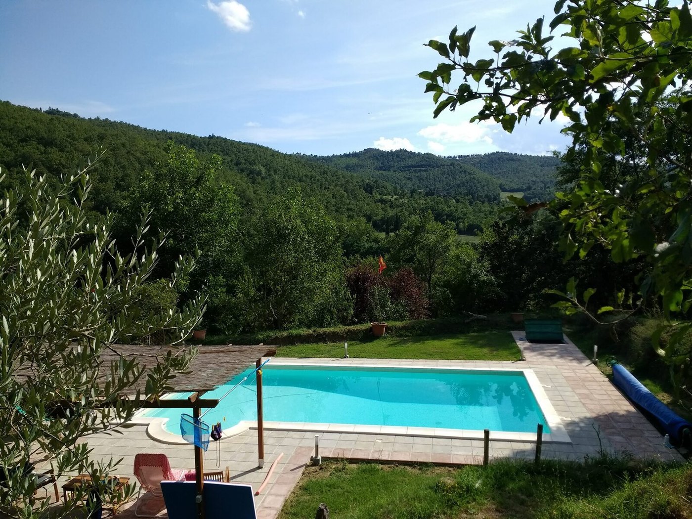 The private swimming pool on the second garden level, looking across the wooded Umbrian hills