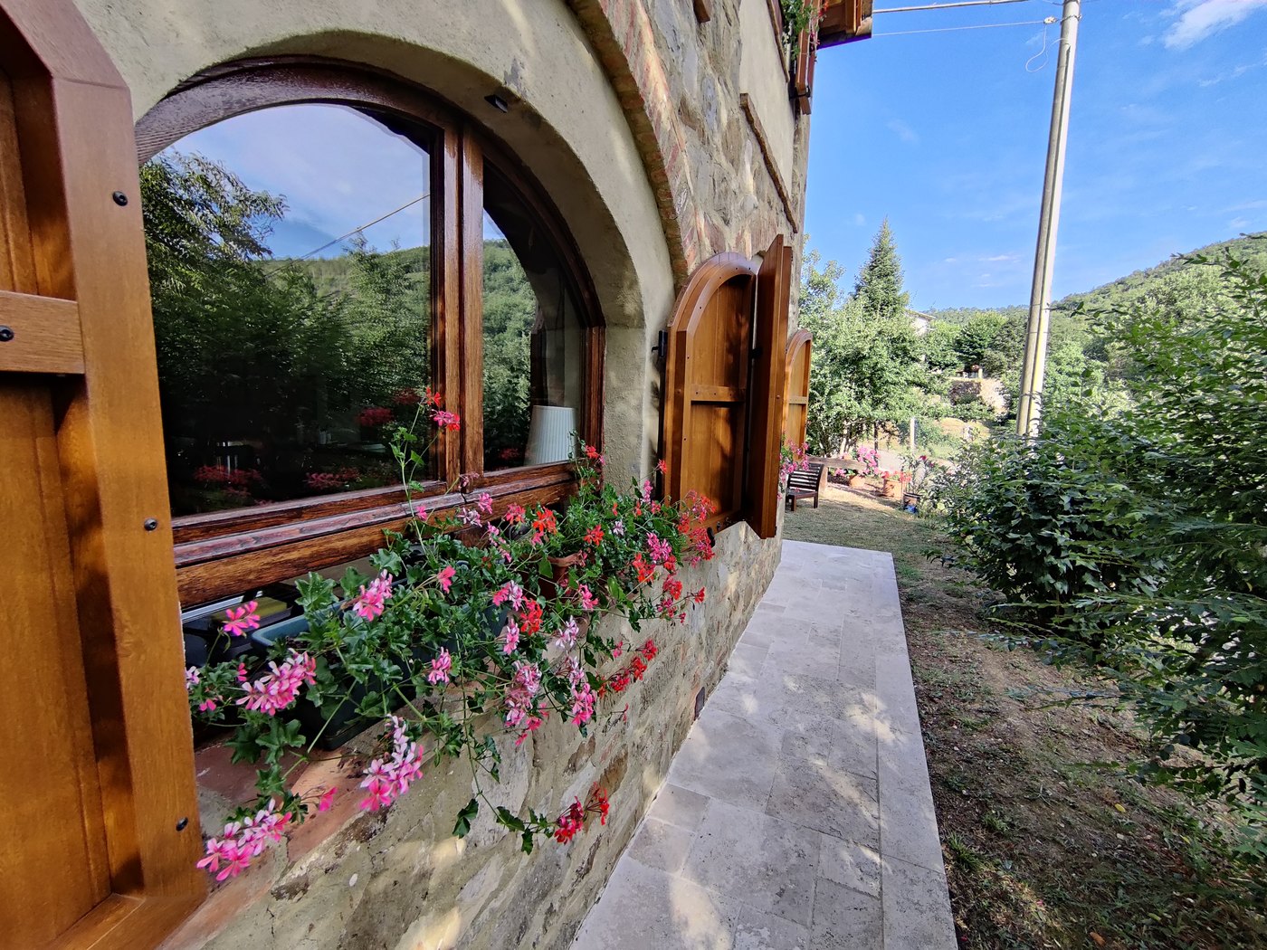 An arched kitchen window opening towards the garden