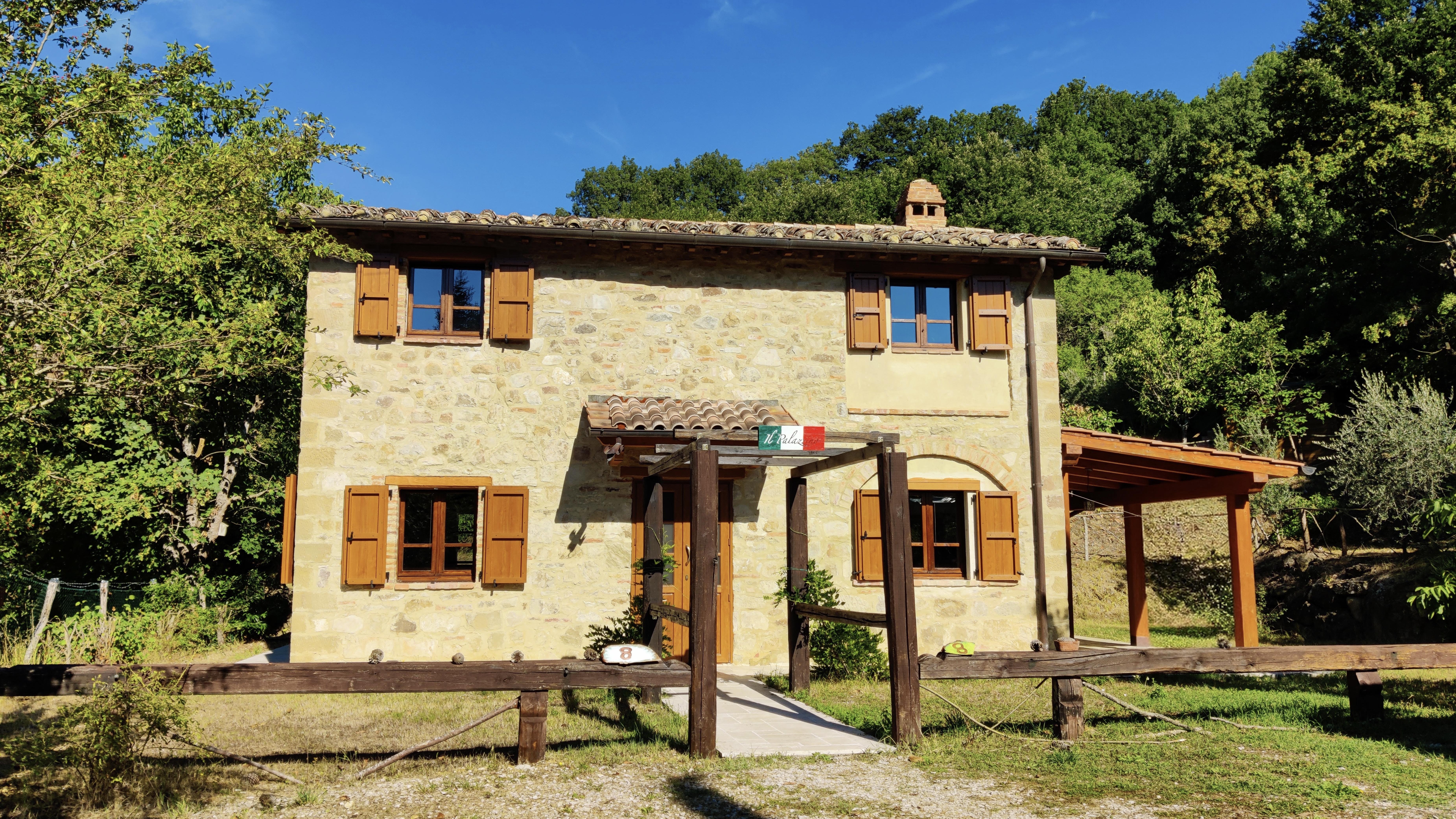 Il Palazzino’s pergola with marble floor overlooking the
            private pool and forested valley