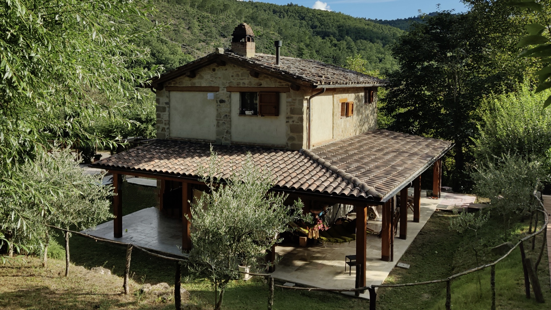 Shaded pergola with marble‑based floors and valley view